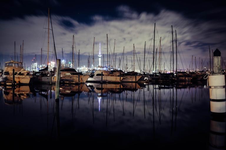 The photograph was taken at Westhaven, Auckland City using Fujifilm xt10 18-55mm lens. The photo is trying to capture the Auckland city by night by emphasizing the sailing boats and the iconic sky tower.